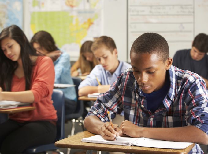 Students writing in notebooks.