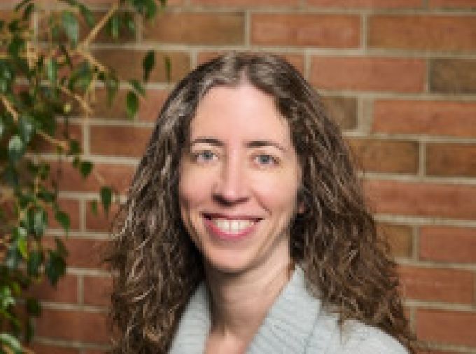 Portrait of Erica Frankenberg against brick wall